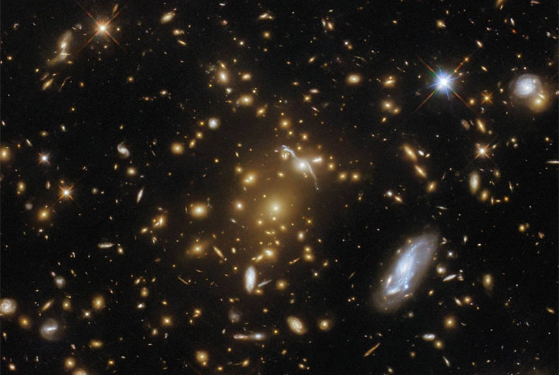 Hubble space telescope images light-bending galaxy cluster