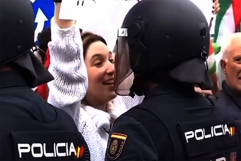 Watch: Woman Kisses, Winks at Policeman during Anti-Israel Protest in Spain
